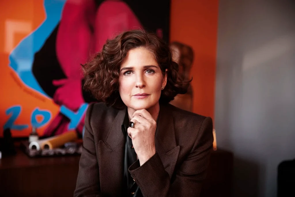 Emma O'Neill photographed in front of colourful abstract artwork