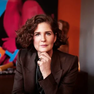 Emma O'Neill photographed in front of colourful abstract artwork